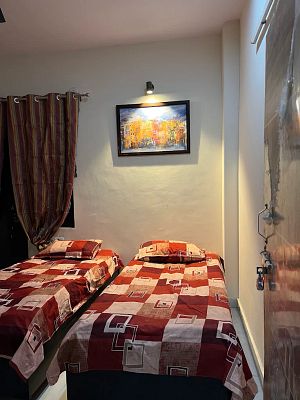 Twin bedroom with red quilts